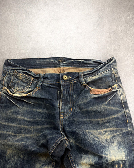 AVH denim front waist close-up with brass button, tan lining and leather trim pocket