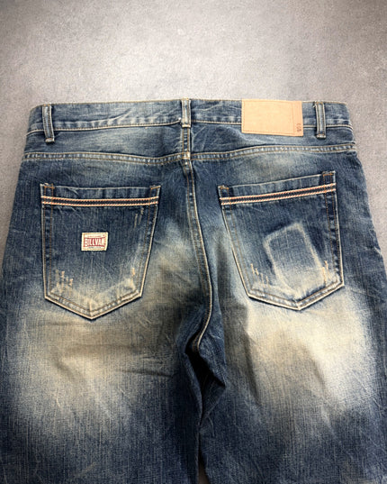 BILLVAN denim back waist close-up with red logo patch and contrast-stitched pockets