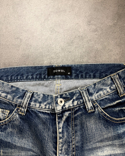 DOWBL denim waistband close-up showing black woven label, size 42 tag and silver button
