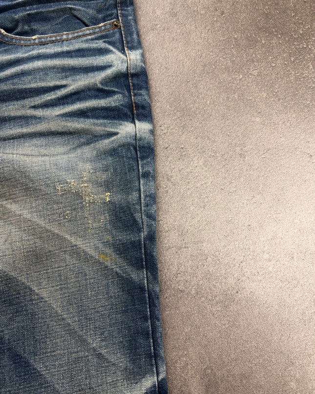 DPSR denim side close-up showing thigh distressing, seam and faded indigo texture