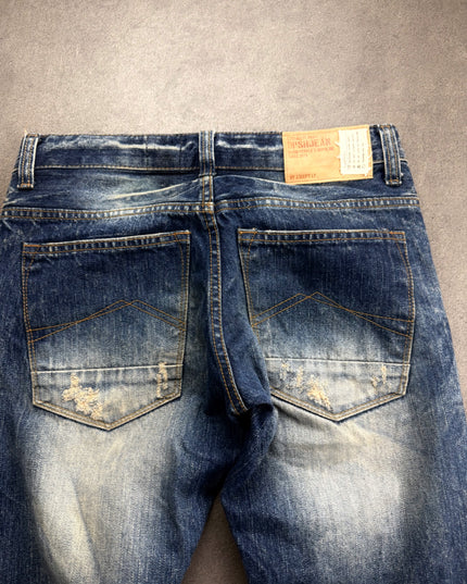 DPSR denim back close-up showing leather-look DPSRJEAN patch and distressed pockets