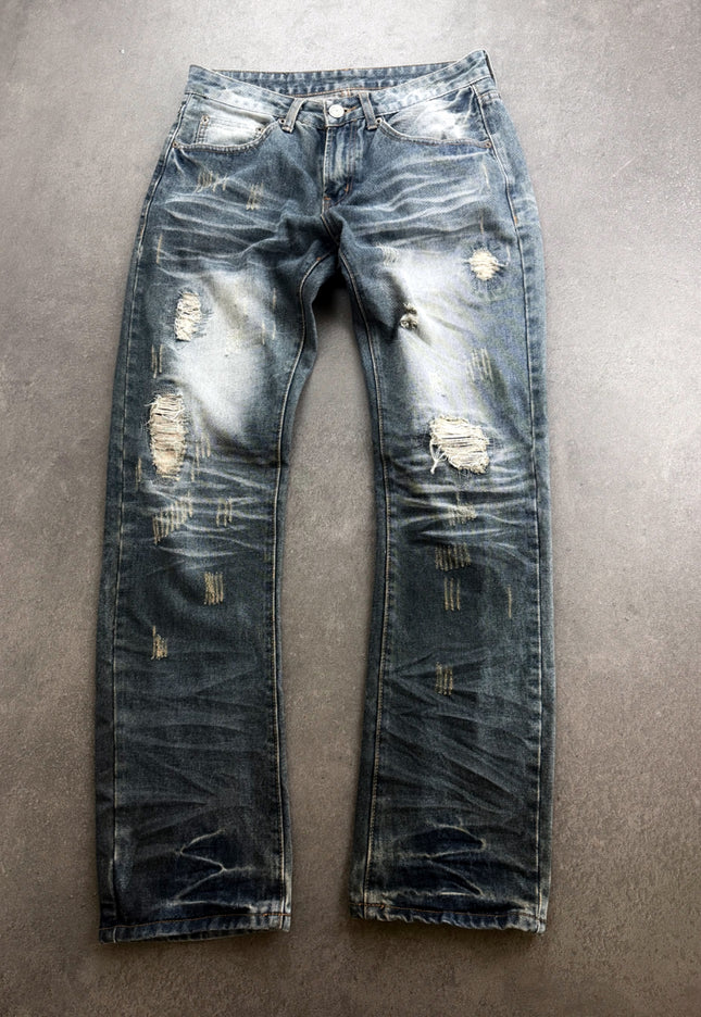 HEISEI distressed faded straight denim, front view laid flat on grey floor