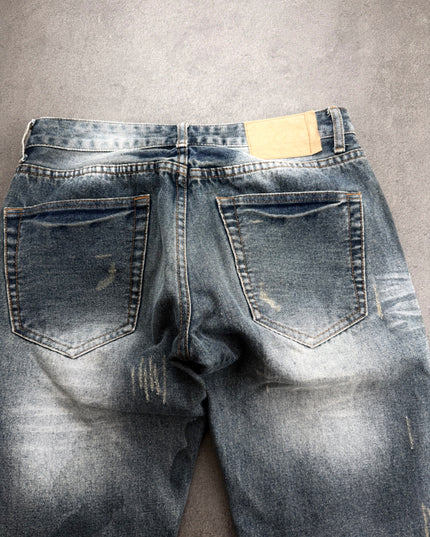 HEISEI denim back close-up showing pockets, leather-look patch and scratched fading