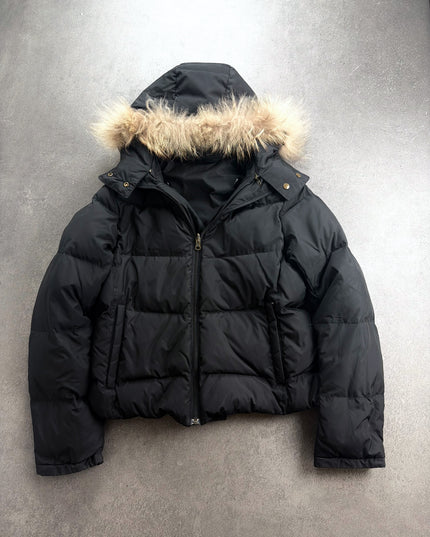 Heisei black puffer jacket with fur hood, front view laid flat on grey floor