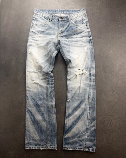 IMPROVES light wash distressed bootcut denim laid flat, front view with knee rip