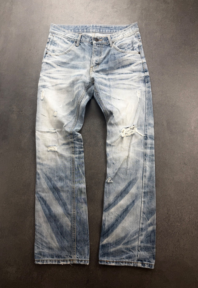 IMPROVES light wash distressed bootcut denim laid flat, front view with knee rip