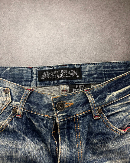 Red Pepper denim waistband close-up with woven brand label and engraved button