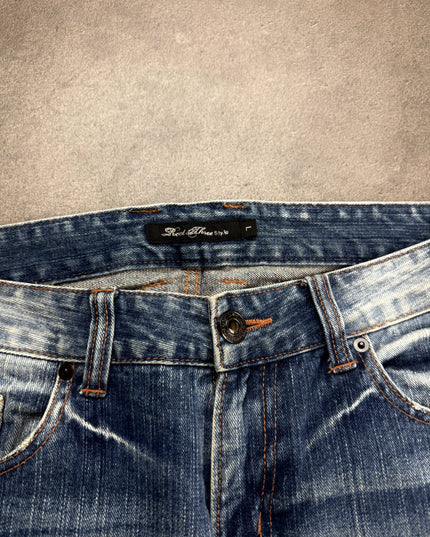 ROOT THREE denim detail of bleached crease and whisker fading across the thigh and knee