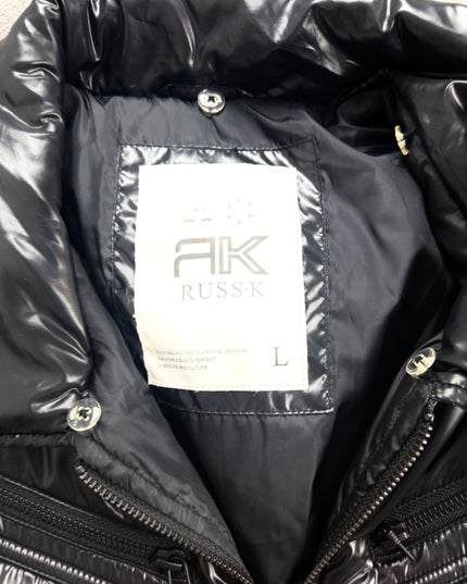 Russ K black puffer jacket detail of the sleeve patch and quilted shoulder