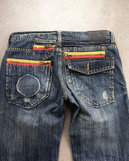 RUSS K denim back close-up of yellow and red zip pockets, ring imprint and leather patch