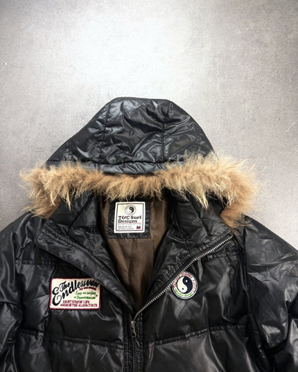 T&C Surf puffer jacket collar close-up with brand label, yin-yang patch and Endless Wave patch