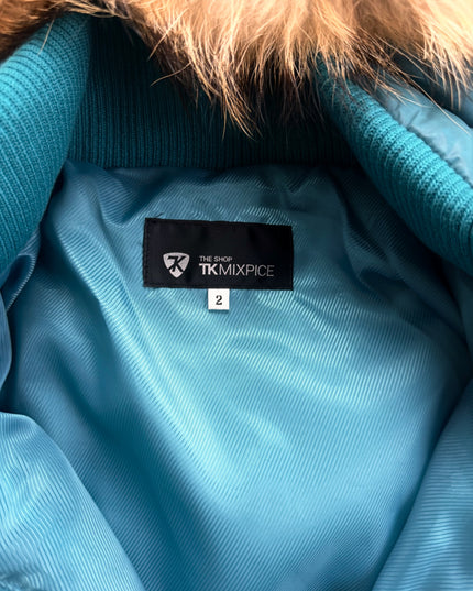 Takeo Kikuchi puffer sleeve cuff detail showing quilted teal shell and glossy finish