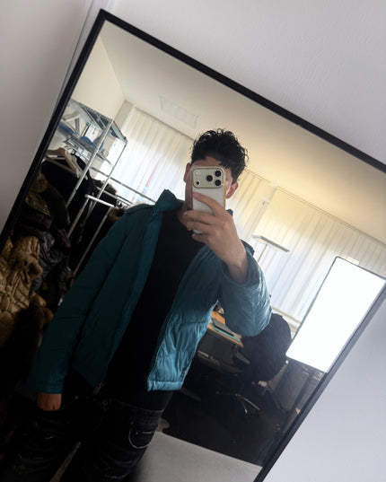 Takeo Kikuchi teal puffer hem detail with drawcord toggle and zip pocket