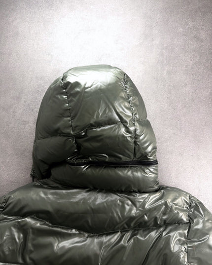 Takeo Kikuchi puffer hood from behind with zip detail on glossy olive shell